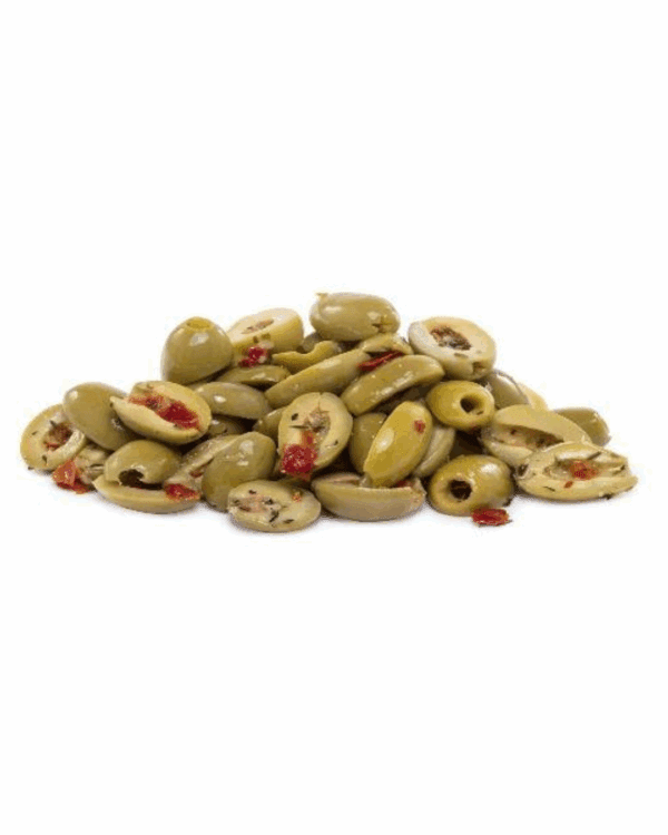 Bowl of sliced green olives with red pepper and herbs in oil dressing.