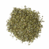 Dried, crushed green leaves on a white background, used as seasoning or herb in cooking.