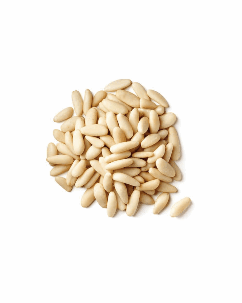 Pile of smooth, pale cream pine nuts on a white background.
