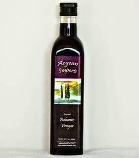 Dark glass bottle of Aegean Imports gourmet balsamic vinegar, 16.9 fl oz, with scenic label.