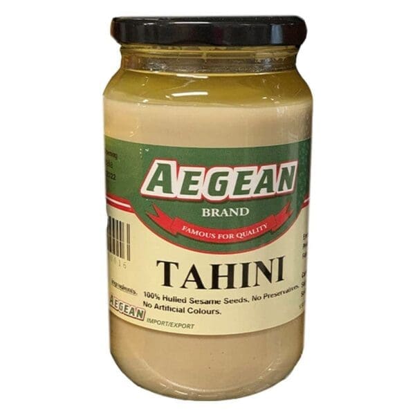 Jar of Aegean tahini, 100% hulled sesame, no preservatives, black lid, green/beige label.