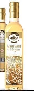 Bottle of Aegean white wine vinegar, golden cap, grapevine label, partial bottle in background.