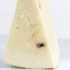 Wedge of hard, aged cheese with crumbly texture and dark spots on off-white surface.