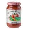 Jar of basil tomato sauce with checkered lid and illustrated label of tomatoes, basil, onions.