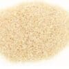 Pile of small, uniformly beige uncooked rice on a plain white background.