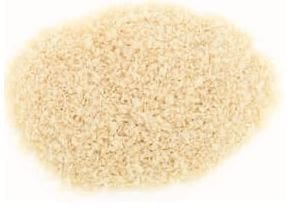 Pile of small, uniformly beige uncooked rice on a plain white background.
