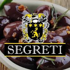 Bowl of dark olives with herbs and spices, featuring a crest and "SEGRETI" in bold letters.