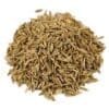 A pile of brown cumin seeds on a white background, elongated with a ridged texture.
