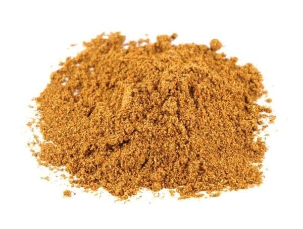 Brown, finely ground spice on white background for cooking or seasoning.