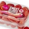 Clear plastic container of fresh cherry tomatoes labeled "Sweet Delights," 200 grams.