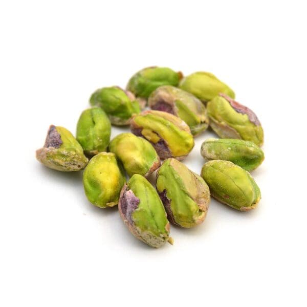 Cluster of unshelled pistachios on a white background, showing green and purple hues.