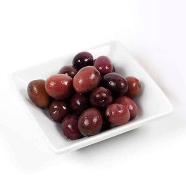 Small white dish with glossy dark purple and brown olives.