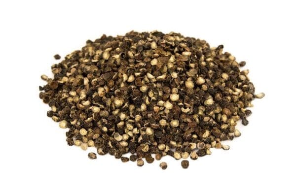 Dried cracked black peppercorns in various shades on a plain white background.