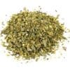 Pile of dried mixed herbs with green and brown leaves in varied sizes and coarse texture.