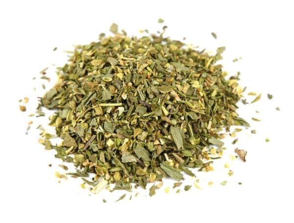 Pile of dried mixed herbs with green and brown leaves in varied sizes and coarse texture.