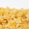 Small, cubed, dried pineapple pieces with sugary coating, light yellow color.