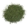 A pile of finely chopped dried dill leaves on a white background.