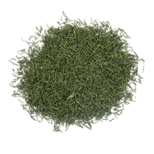 A pile of finely chopped dried dill leaves on a white background.