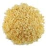 Finely chopped garlic pile; yellowish-white, uneven texture, used in cooking.