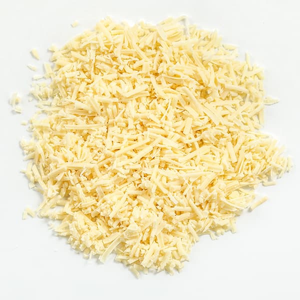 Finely grated pale yellow cheese on a white surface.