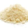 Finely shredded Parmesan cheese pile with light, fluffy texture on plain background.