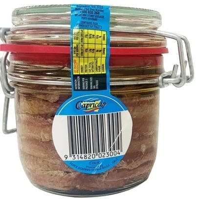 Glass jar with metal latch, red seal, preserves inside, blue label, barcode visible.