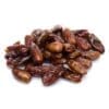 Glossy brown dates piled on a white background, shiny and whole.