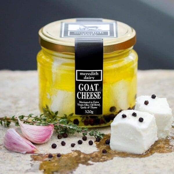 Jar of 320g goat cheese marinated in olive oil with garlic, thyme, and peppercorns.