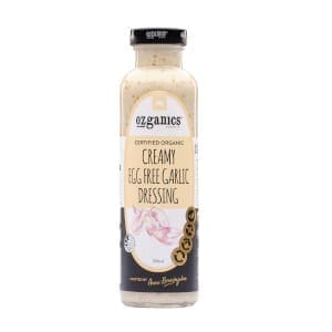 Ozganics organic creamy egg-free garlic dressing in a clear bottle with black cap and garlic label.