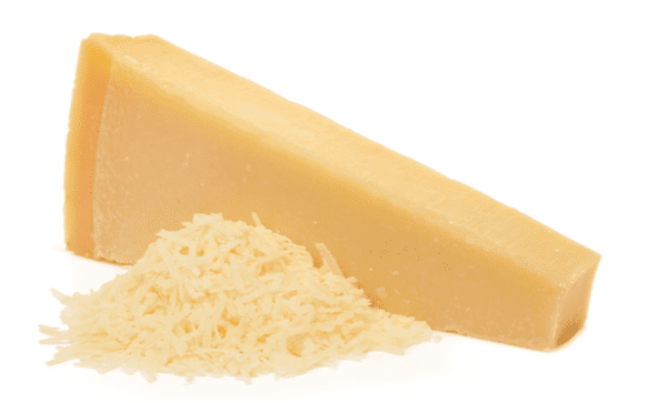 Wedge of pale yellow hard cheese with grated cheese on a white background.