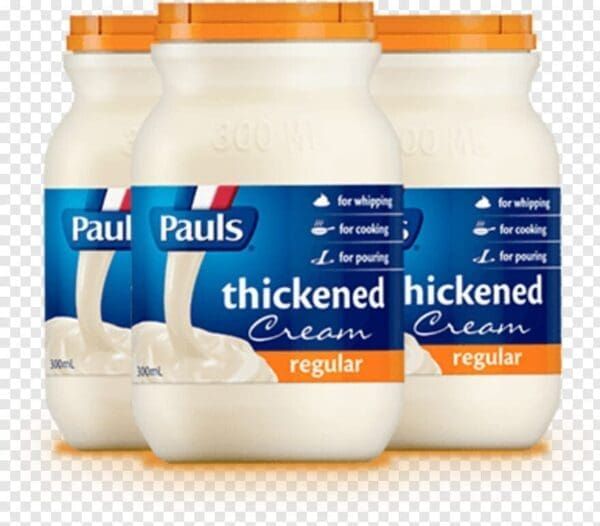 Three jars of Pauls 300ml thickened cream with orange lids, labeled for whipping and cooking.