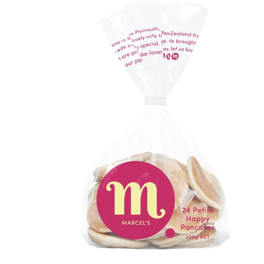 Plastic bag with 24 small pancakes labeled "Petite Happy Pancakes," 200g, pink logo.