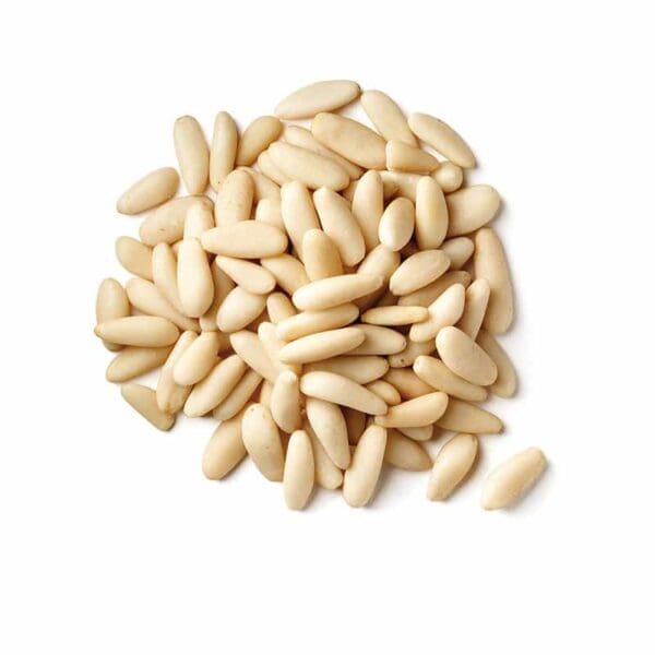 Pile of smooth, pale cream pine nuts on a white background.