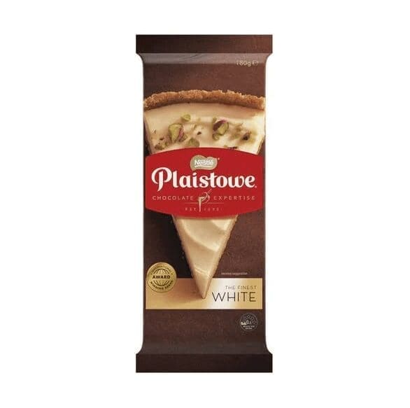 Plaistowe white chocolate package, dessert with nuts, brown background, award recognition.