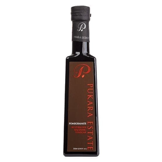 Tall glass bottle labeled "Pukara Estate" pomegranate balsamic vinegar, 250ml capacity.