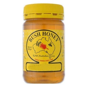 Jar of Bush Honey, yellow lid, label with Australia outline, bees, 500g, "Raw Australian Honey."