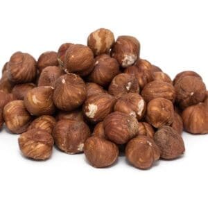 Pile of raw hazelnuts with brown shells on a white background.