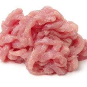Small pile of raw, pink minced meat on white background, soft finely ground texture.