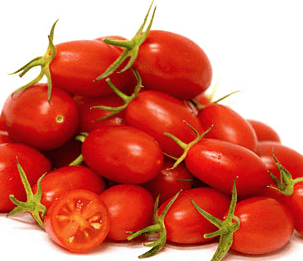 Pile of ripe grape tomatoes with smooth skin, green stems, and one sliced open, showing seeds.