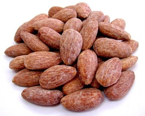 Roasted almonds pile with brown, textured surface and dry exterior typical of such nuts.