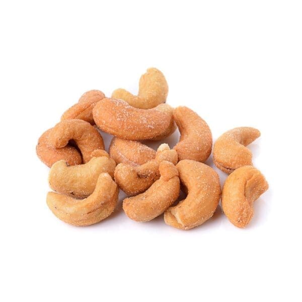 Roasted and salted cashew nuts on a white background.