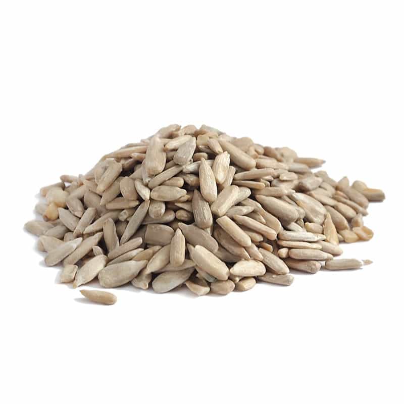 Pile of shelled sunflower seeds on a plain white background.