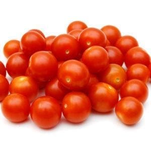 Cluster of shiny, red cherry tomatoes stacked on a plain white background.