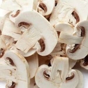 Sliced white mushrooms with visible gills, showcasing a fresh and crisp appearance.