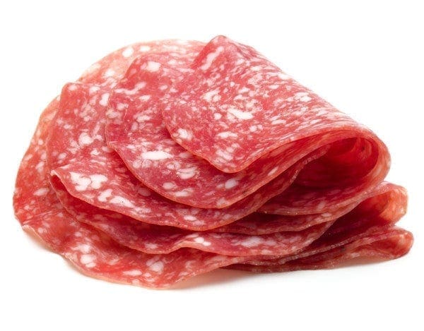 Thinly sliced salami with a marbled pattern of red meat and white fat.