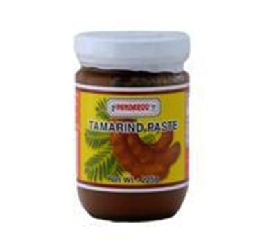 Jar of tamarind paste with white lid, yellow label, and tamarind pods illustration.