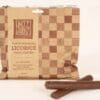 Packet of Uncle John's black molasses licorice, chocolate-coated, with two licorice sticks.