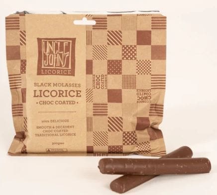 Packet of Uncle John's black molasses licorice, chocolate-coated, with two licorice sticks.