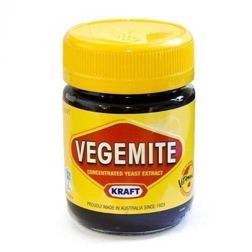 Jar of Vegemite, yellow lid, label with Kraft logo, made in Australia.