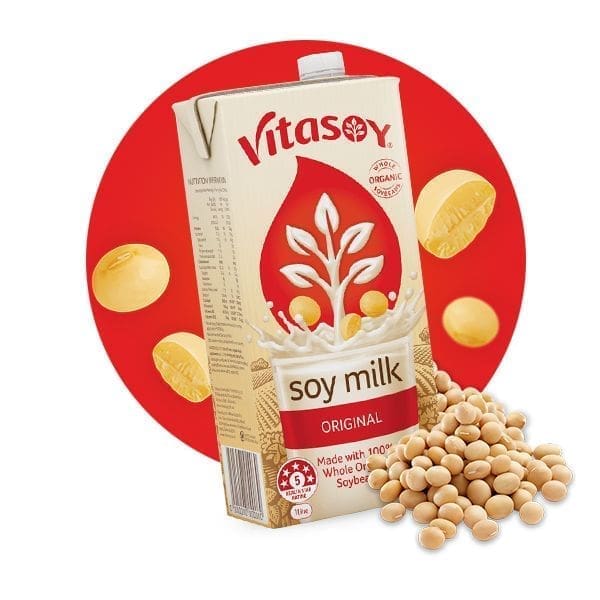 Vitasoy Original Soy Milk carton with red circular background and scattered soybeans.